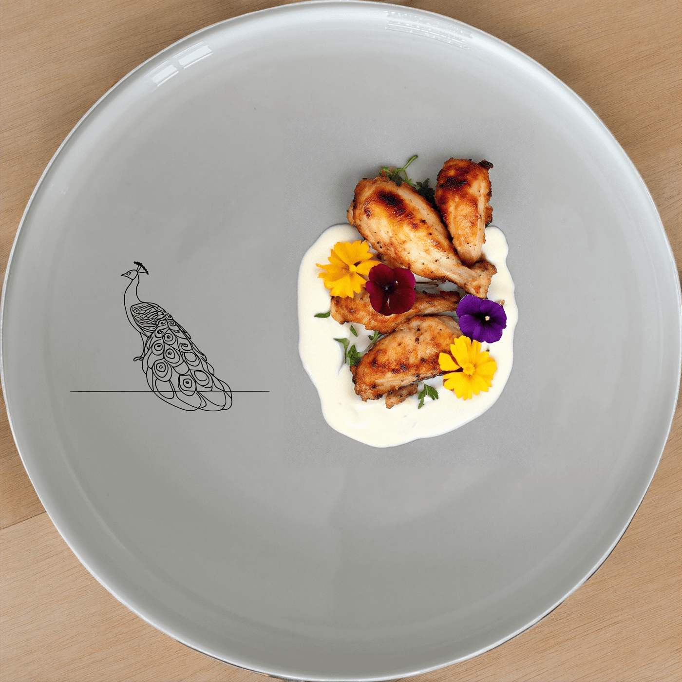 The Male Peacock Dinner Plate Set of 4 features a minimalist design with a subtle peacock silhouette, perfect for modern dining settings.