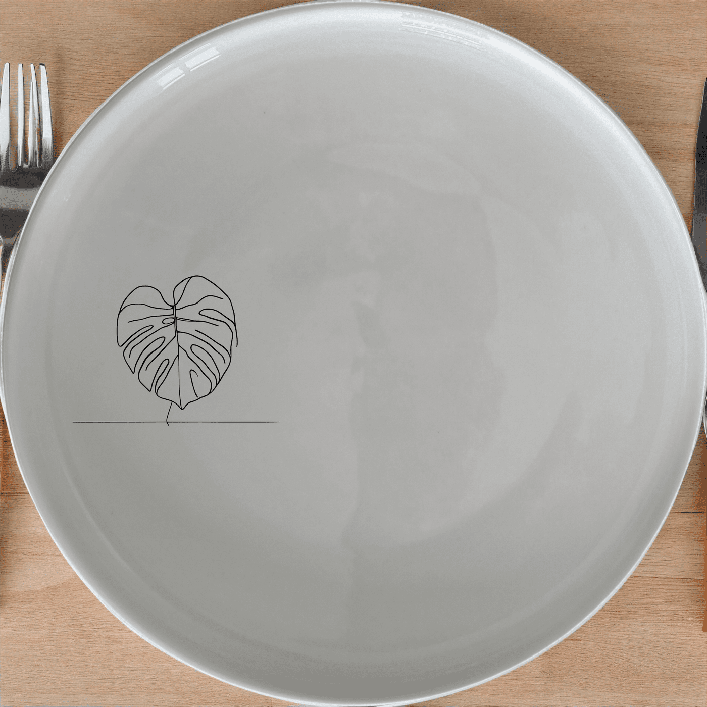 Monstera Deliciosa Dinner Plate Set of 4 is a stunning addition to any dining table, featuring elegant leaf designs on white ceramic plates.