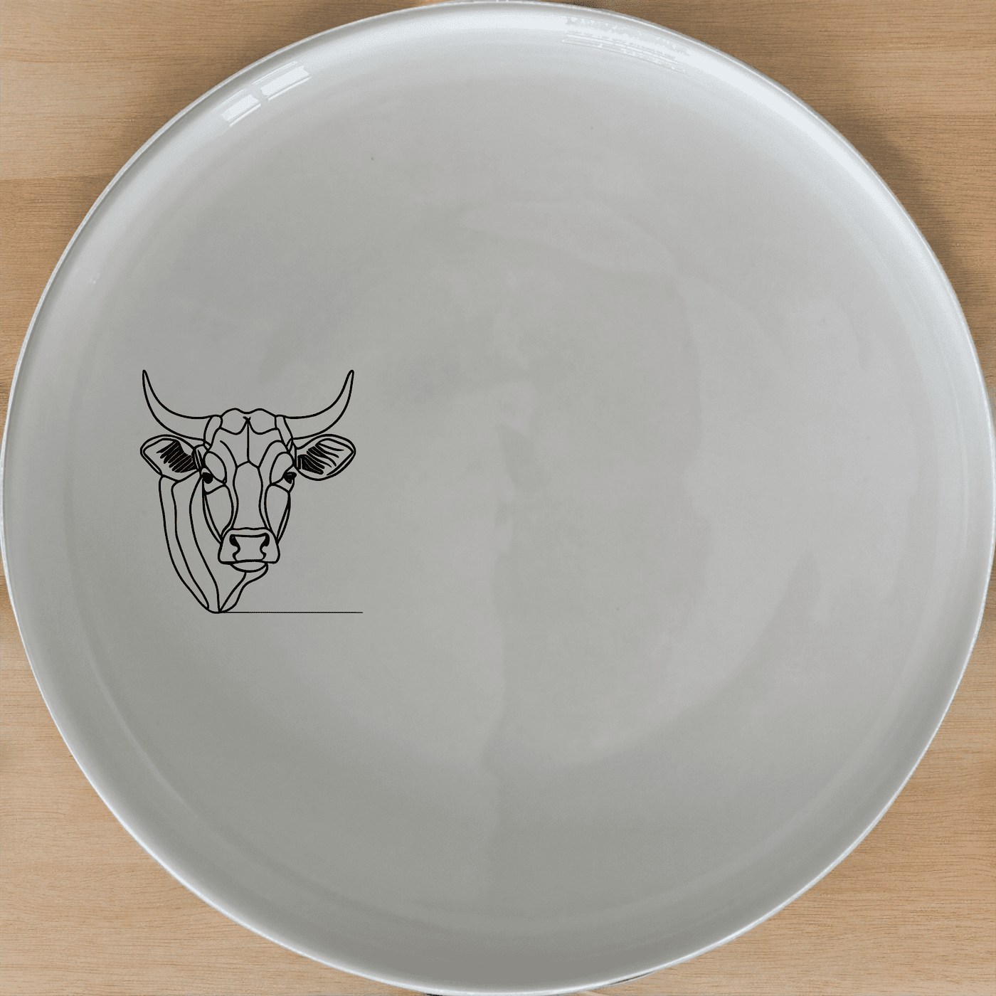 The Nguni Cattle Cow Head Side Plate Set of 4 features a striking silhouette of a Nguni cow head, perfect for adding a touch of African artistry to your dining table.