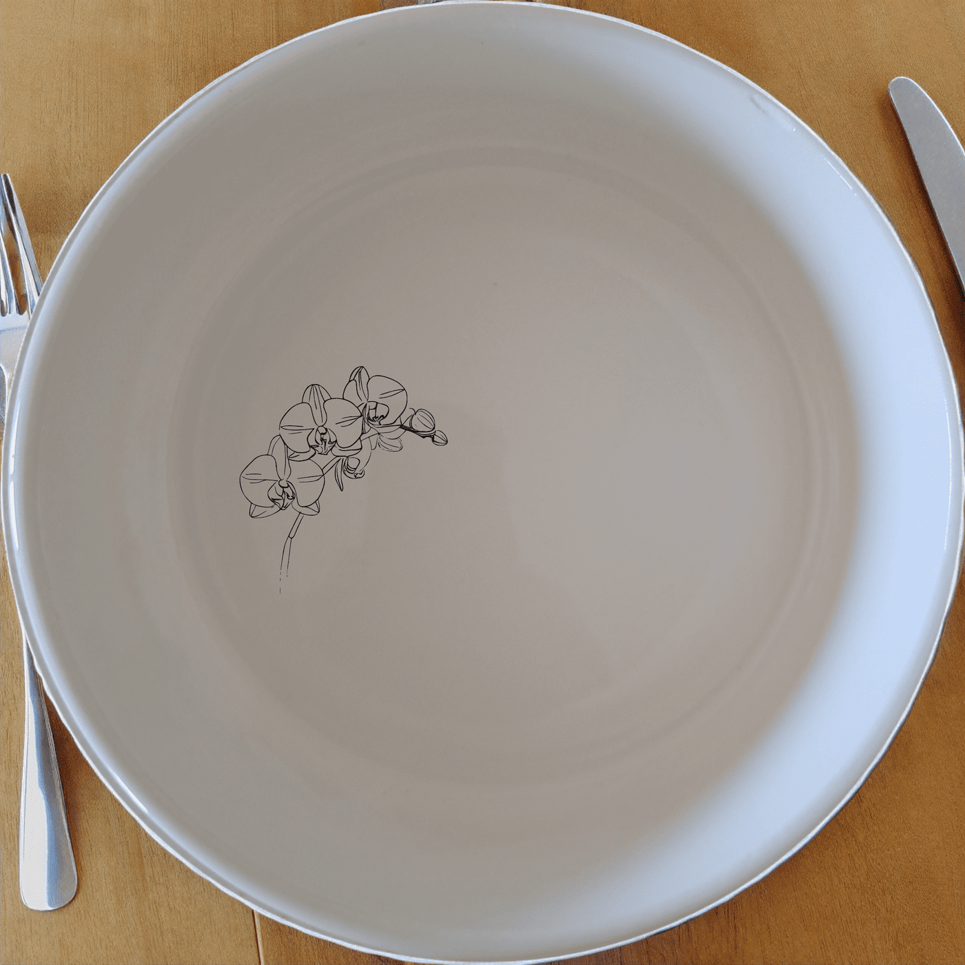 The Orchid Stems Bowl Set of 4 features delicate laser-etched orchid designs on white ceramic bowls, perfect for any dining occasion.
