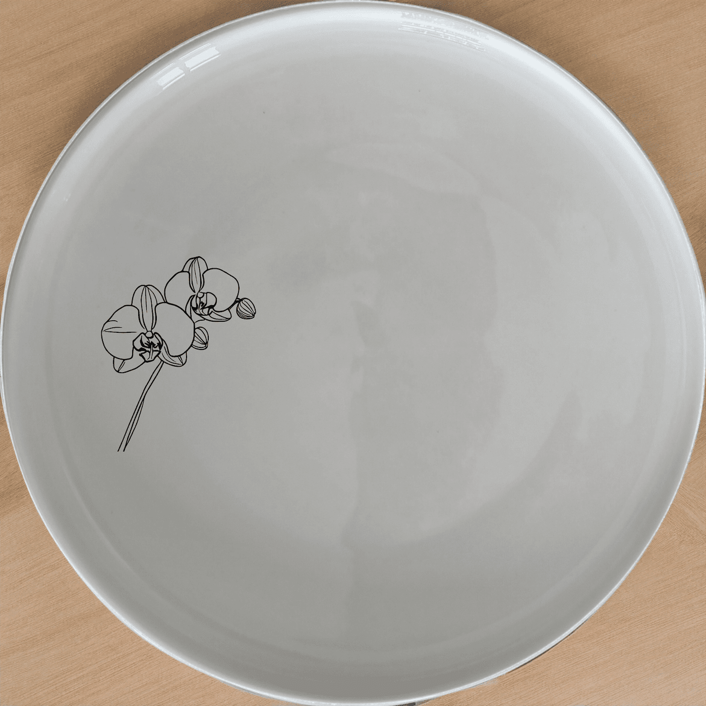 The Orchid Stems Dinner Plate Set of 4 features delicate laser-etched orchid designs on white ceramic plates, perfect for elevating any dining experience.