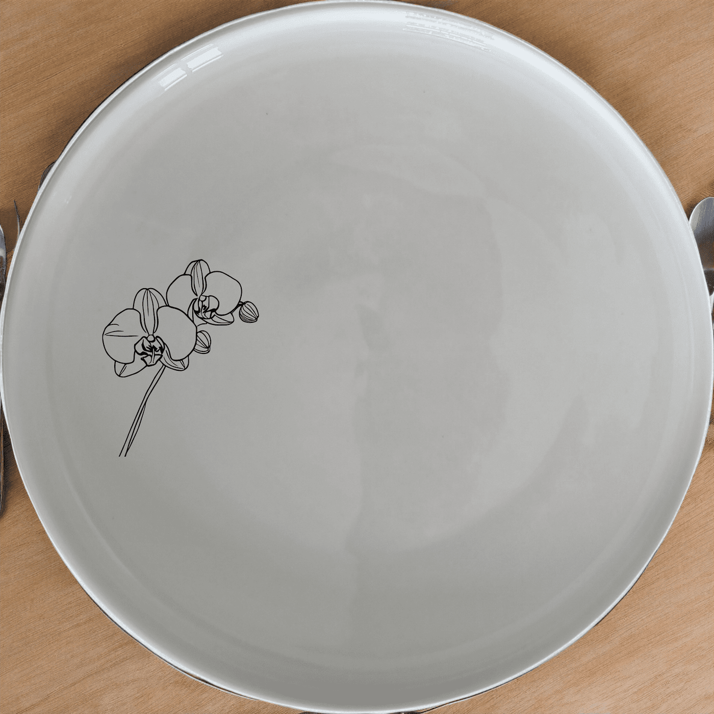 The Orchid Stems Side Plate Set of 4 features delicate laser-etched designs, perfect for adding a touch of nature to your dining table.
