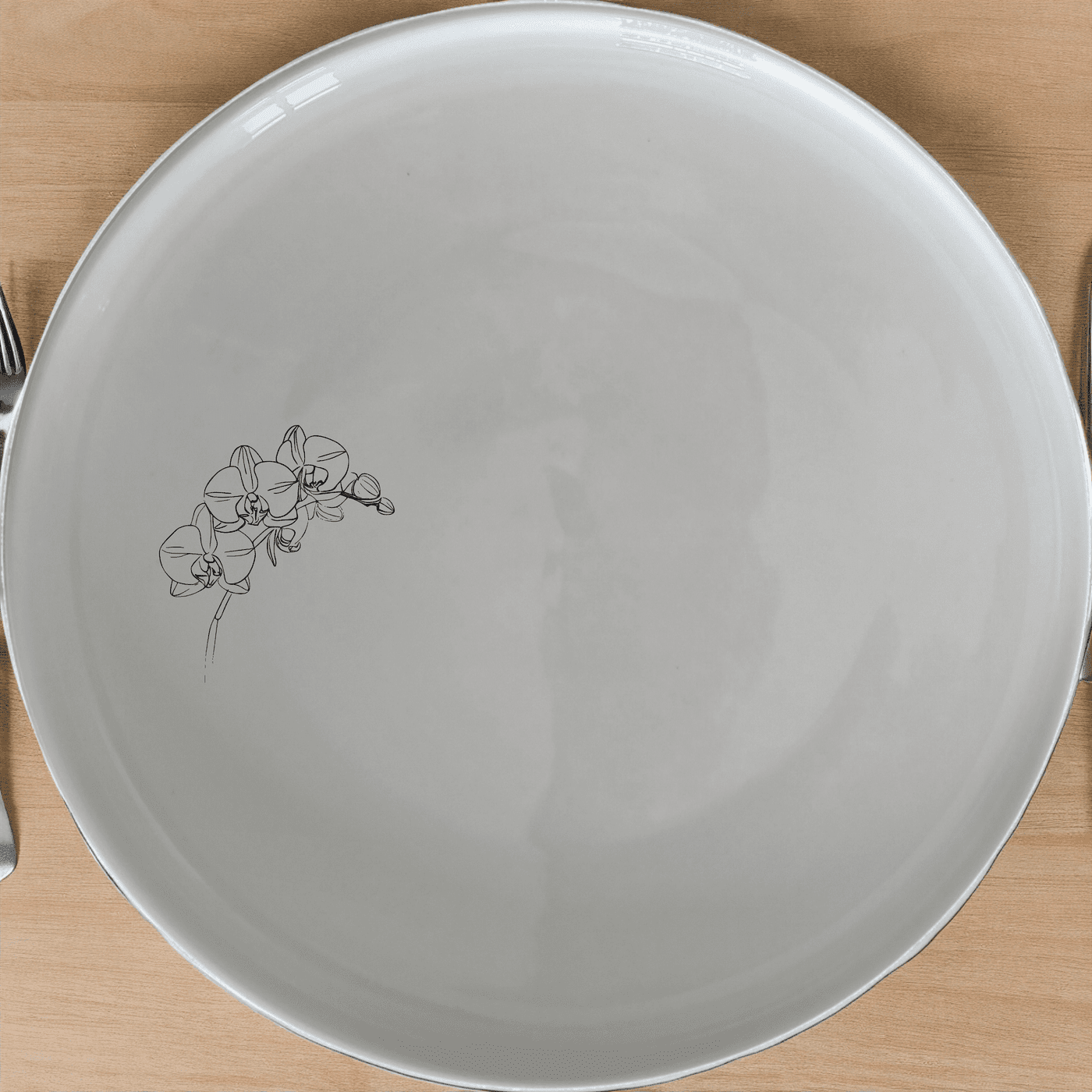 The Orchid Stems Side Plate Set of 4 features delicate laser-etched orchid designs on a pristine white ceramic surface, perfect for adding a touch of nature to any dining setting.
