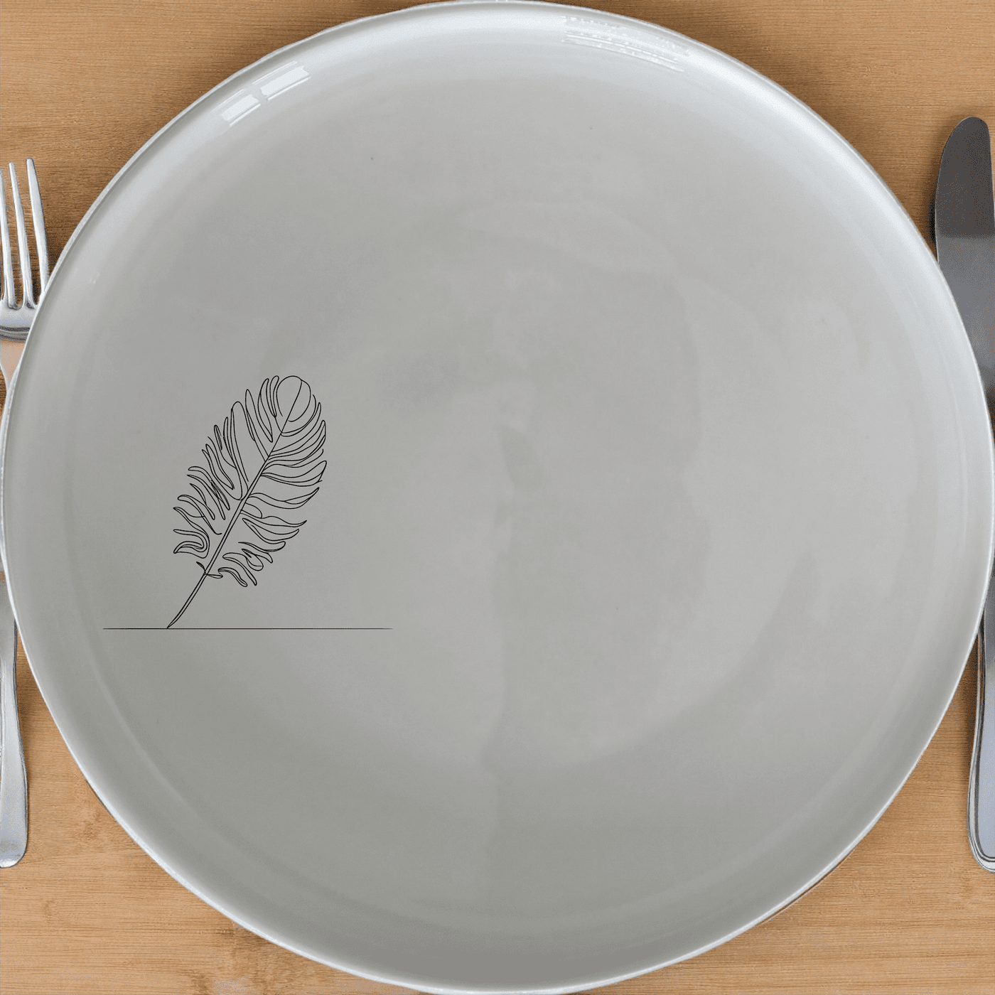 The Ostrich Feather Delicate Dinner Plate Set of 4 features a minimalist design with a subtle ostrich feather motif, perfect for elevating any dining experience.
