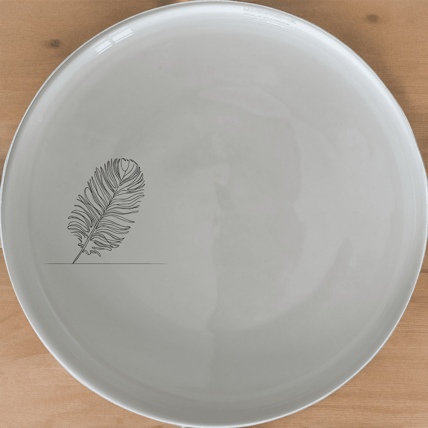 The Ostrich Feather Side Plate Set of 4 adds a touch of sophistication to your dining table with its delicate, detailed design.