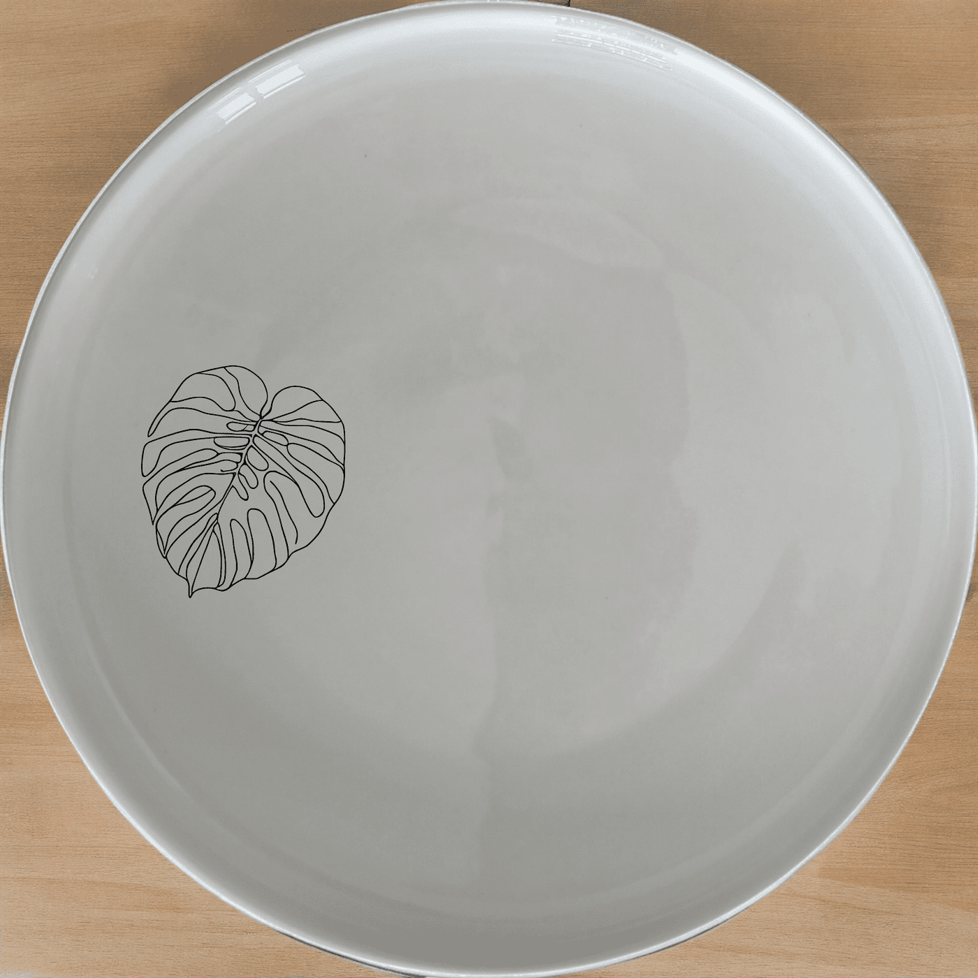 The Oversized Monstera Leaves Dinner Plate Set of 4 adds a touch of nature to your dining table with its elegant design and durable ceramic construction.