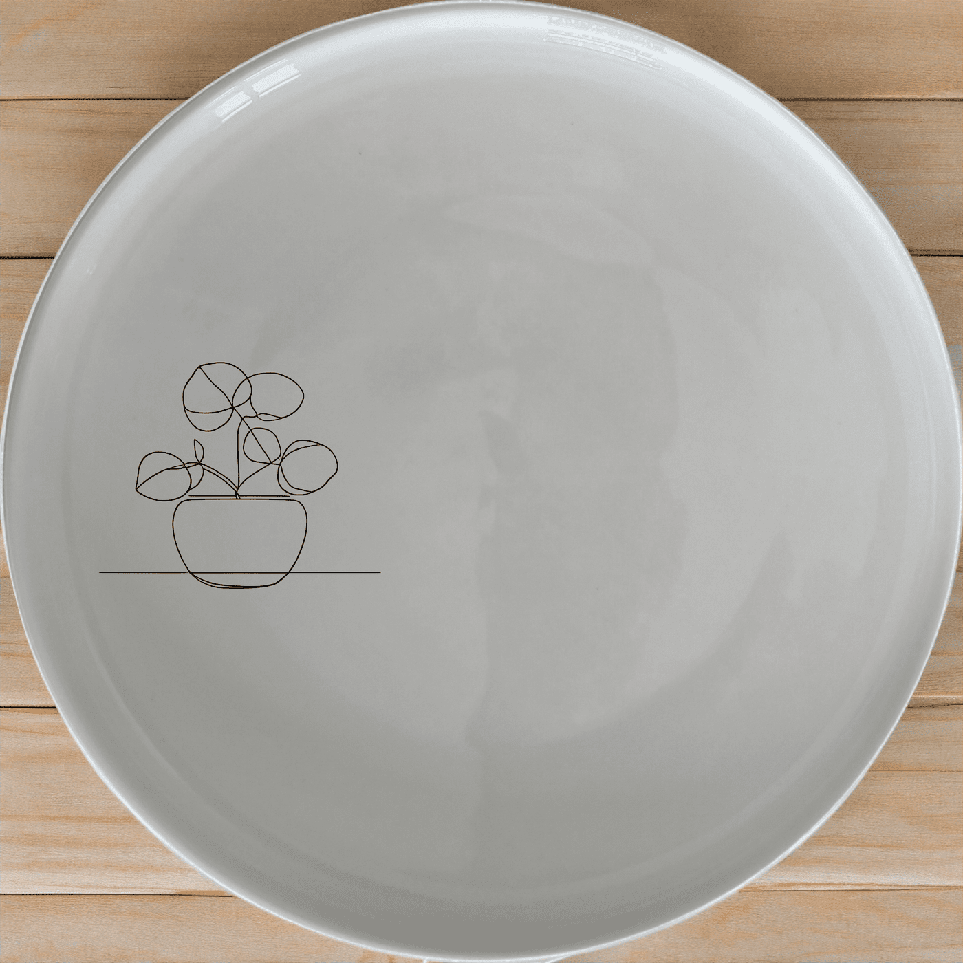 The Pilea Plant Dinner Plate Set of 4 features a minimalist design perfect for modern dining. Crafted from durable ceramic, these plates are dishwasher and microwave safe.