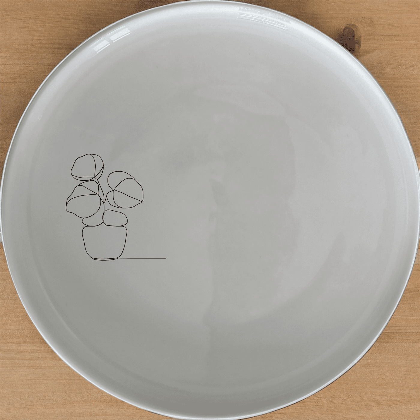 The Pilea Plant Dinner Plate Set of 4 features a minimalist design perfect for modern dining spaces.