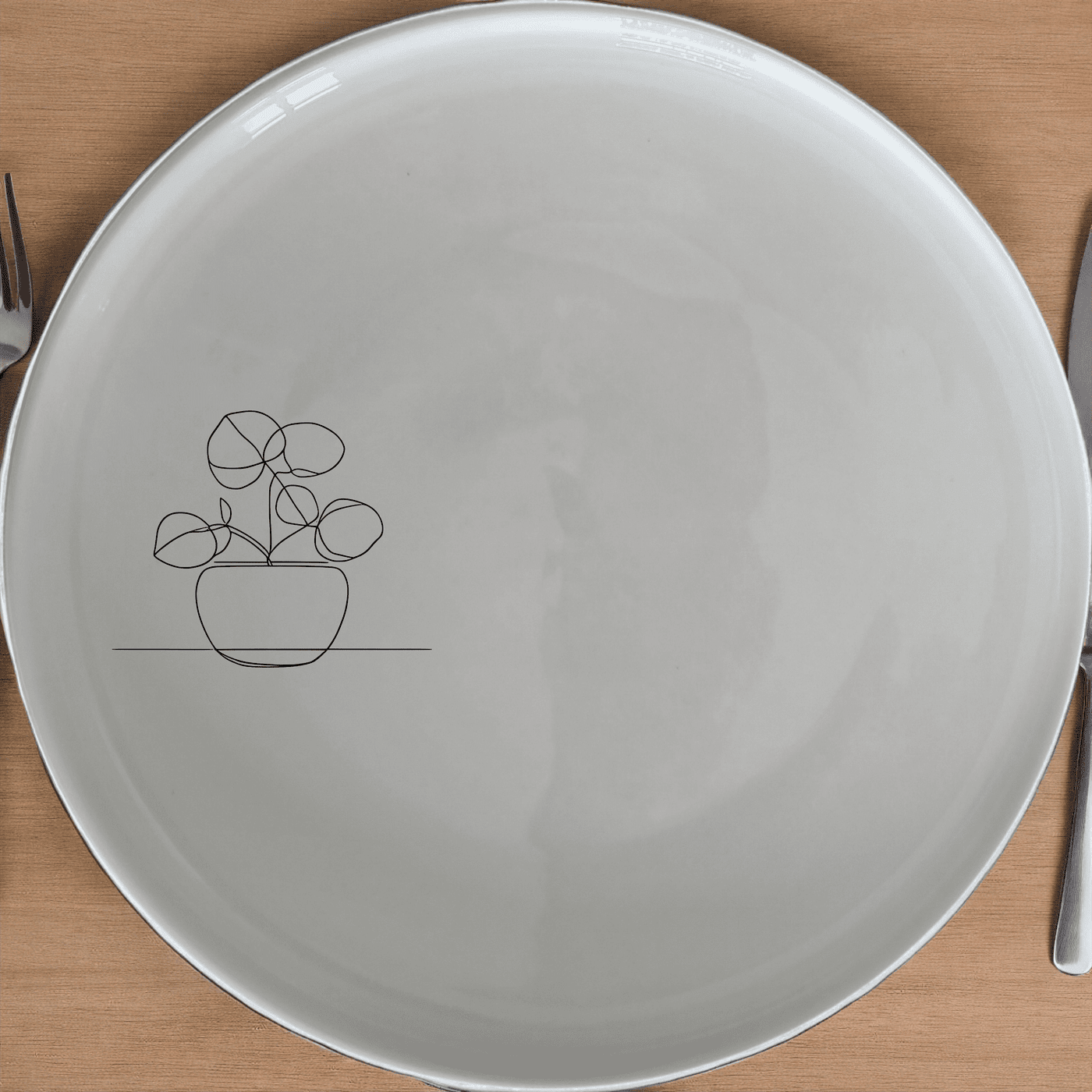 The Pilea Peperomioides Side Plate Set of 4 features a minimalist design with a subtle plant motif, perfect for modern dining settings.