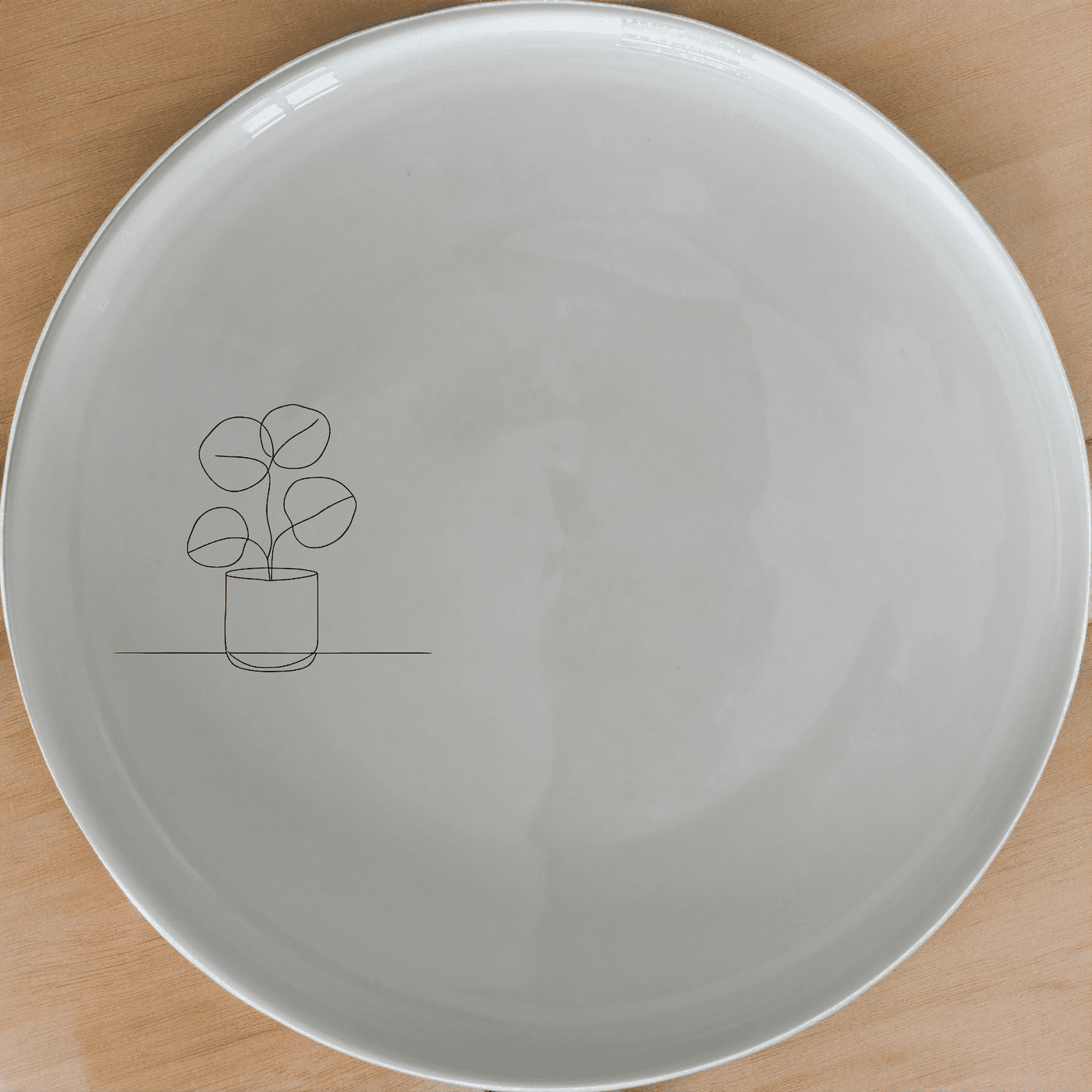 The Pilea Plant Side Plate Set of 4 adds a touch of nature to your dining table with its minimalist design and elegant plant illustration.