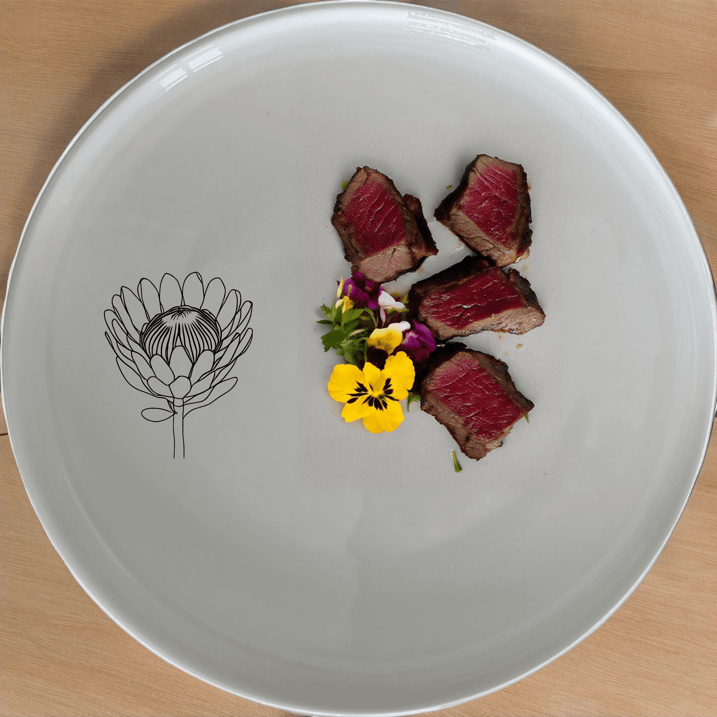 The Pincushion Protea Flower Side Plate Set of 4 features a beautiful laser-etched design on a sleek white ceramic surface, perfect for any dining occasion.
