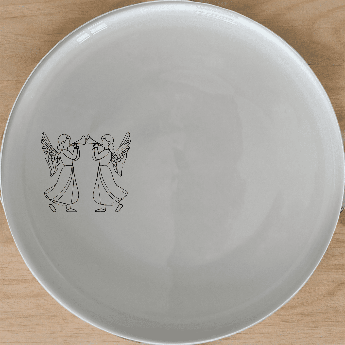 The Angels Trumpet Dinner Plate Set of 4 - Range 1 features elegant silhouettes of angels playing trumpets, perfect for adding a touch of celestial charm to your dining experience.