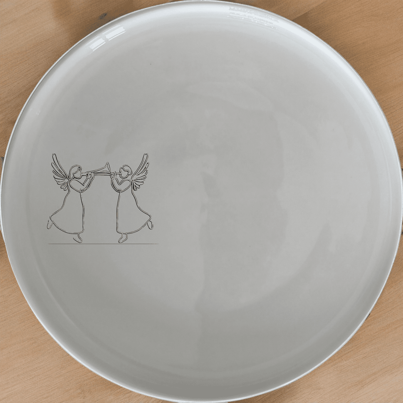 Angels Trumpet Side Plate Set of 4 - Range 2 is a beautiful and elegant set of four white ceramic side plates featuring a laser-etched design of two angels playing trumpets. Perfect for any dining occasion.