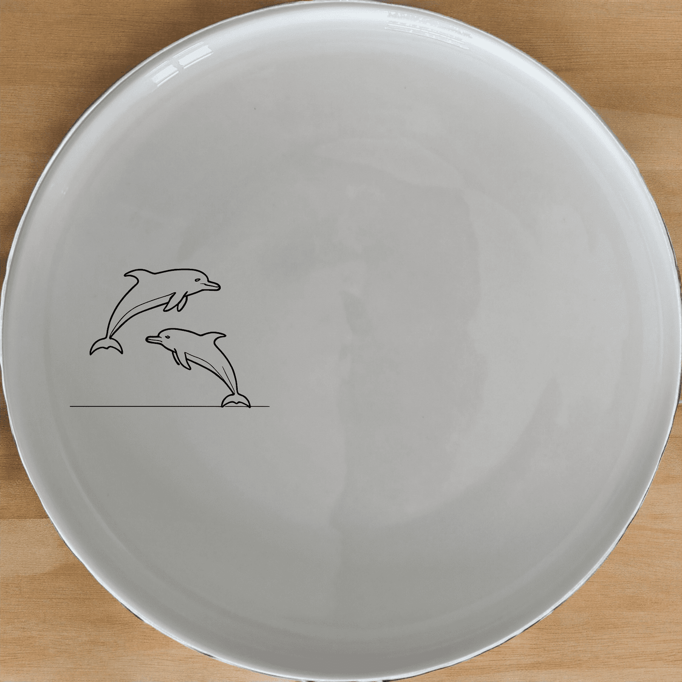 Jumping Dolphins Side Plate Set of 4 - Range 3 is a beautiful set of four white ceramic plates featuring a laser-etched design of two dolphins jumping in unison. Perfect for any occasion, these plates are both stylish and practical.