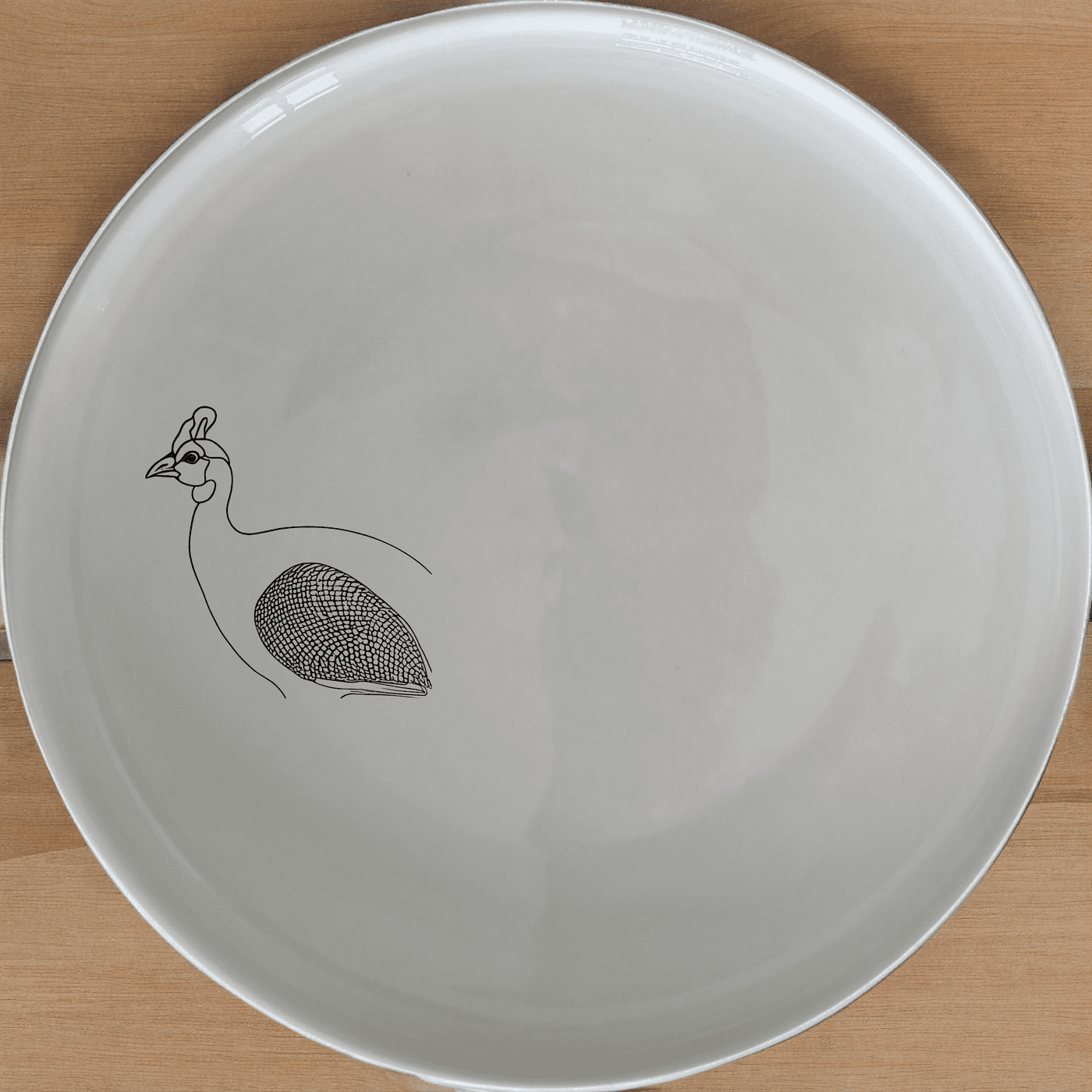 The Helmeted Guineafowl Dinner Plate Set of 4 features elegant laser-etched designs perfect for any dining occasion.