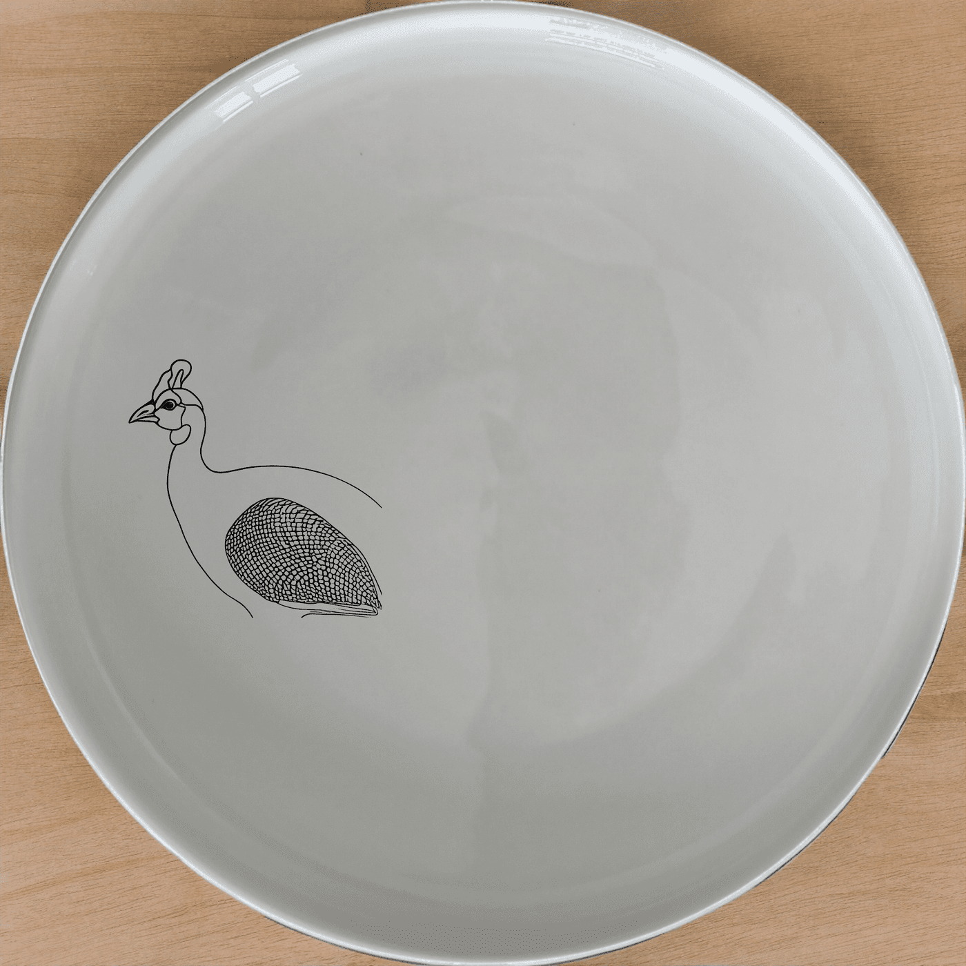 The Helmeted Guineafowl Side Plate Set of 4 features elegant laser-etched designs perfect for any dining table.