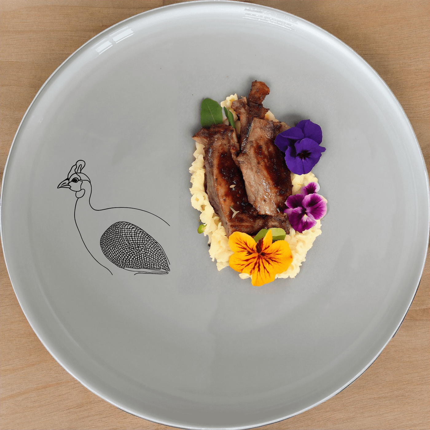 The Helmeted Guineafowl Side Plate Set of 4 features elegant laser-etched designs perfect for any dining table.