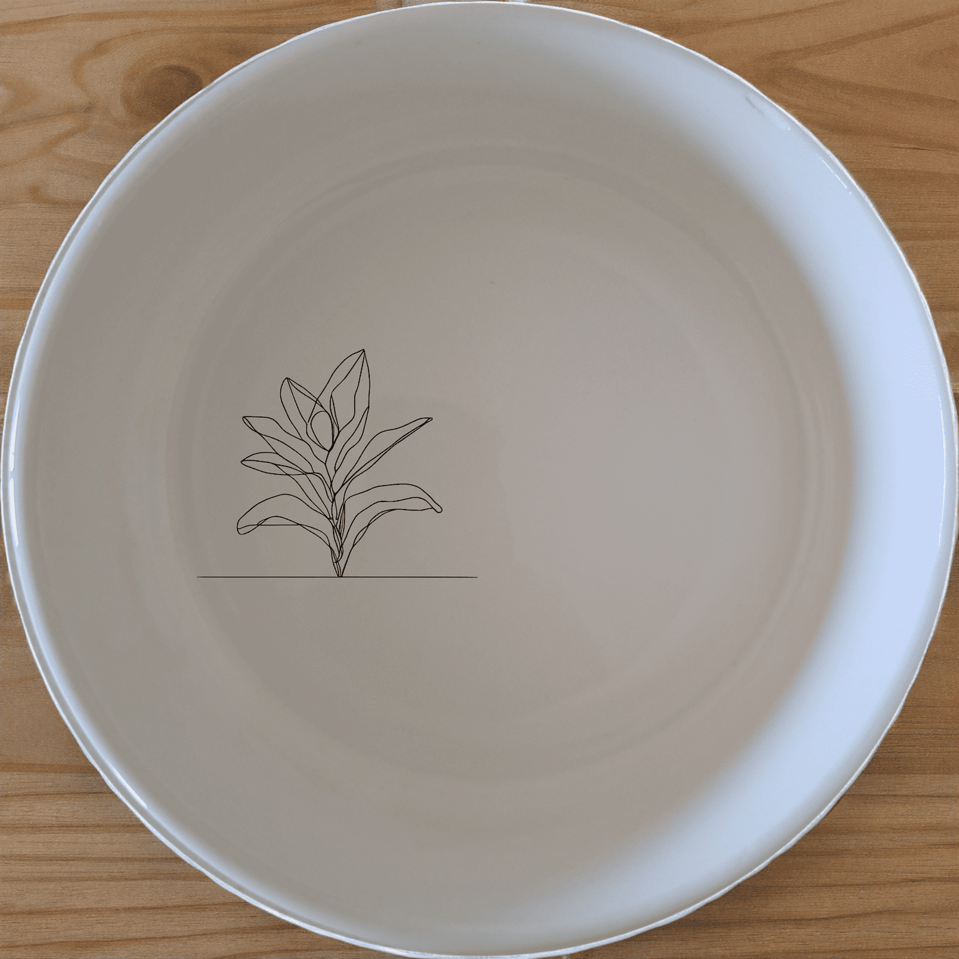 The Stromanthe Triostar Bowl Set of 4 features a modern, minimalist design with subtle botanical accents, perfect for everyday use or special occasions.