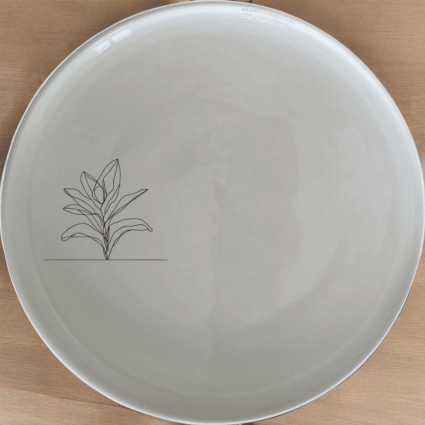 The Stromanthe Triostar Side Plate Set of 4 features a minimalist design with an abstract plant motif, perfect for modern dining settings.