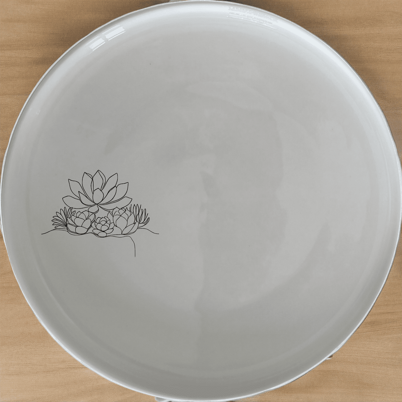 The Succulent Garden Dinner Plate Set of 4 features a modern, minimalist design perfect for any dining occasion.