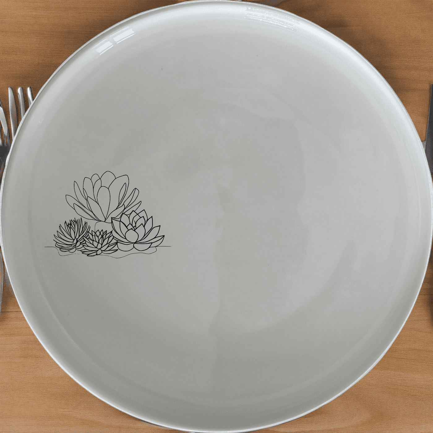 The Succulent Garden Side Plate Set of 4 features a modern, minimalist design perfect for any dining table. Crafted from premium ceramic, these plates are both durable and stylish, ideal for everyday use or special occasions.