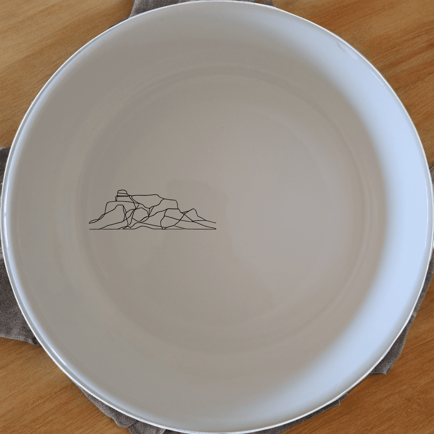 The Table Mountain Bowl Set of 4 features a minimalist design with a subtle silhouette of the iconic mountain range, perfect for everyday use or as a stylish gift.