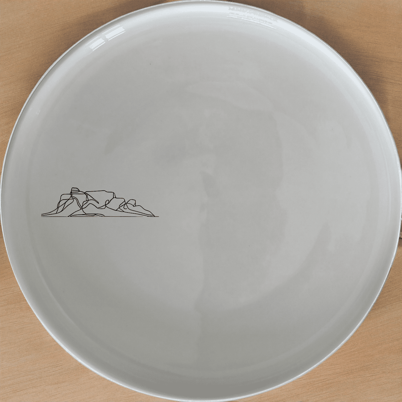 Table Mountain Side Plate Set of 4 is a stunning collection of ceramic plates featuring a minimalist design inspired by the iconic Table Mountain landscape.