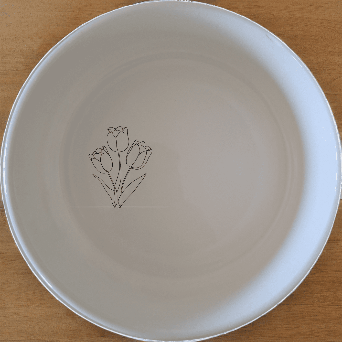 The Tulips Panda Flat Bowl Set of 4 features a delicate line art design of tulips, perfect for everyday use or special occasions.