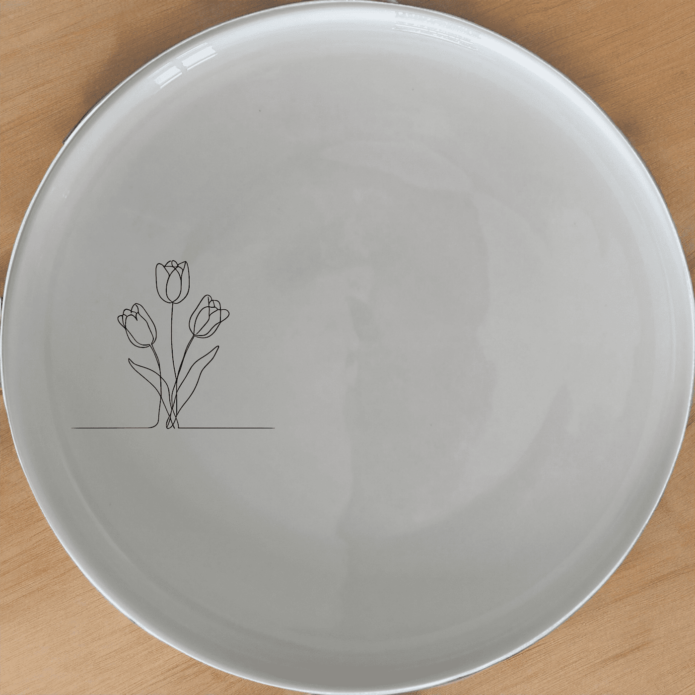 The Tulips Flat Side Plate Set of 4 is a stylish and versatile addition to any dining table, perfect for everyday use or special occasions.