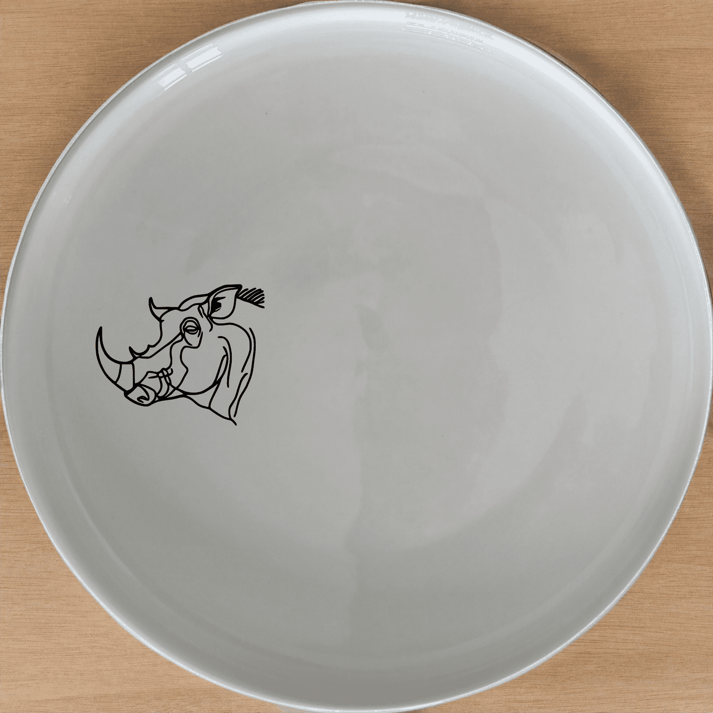 The Warthog Portrait Dinner Plate Set of 4 features a sleek, minimalist design perfect for modern dining. Crafted from durable ceramic, these plates are microwave and dishwasher safe, making them ideal for everyday use.
