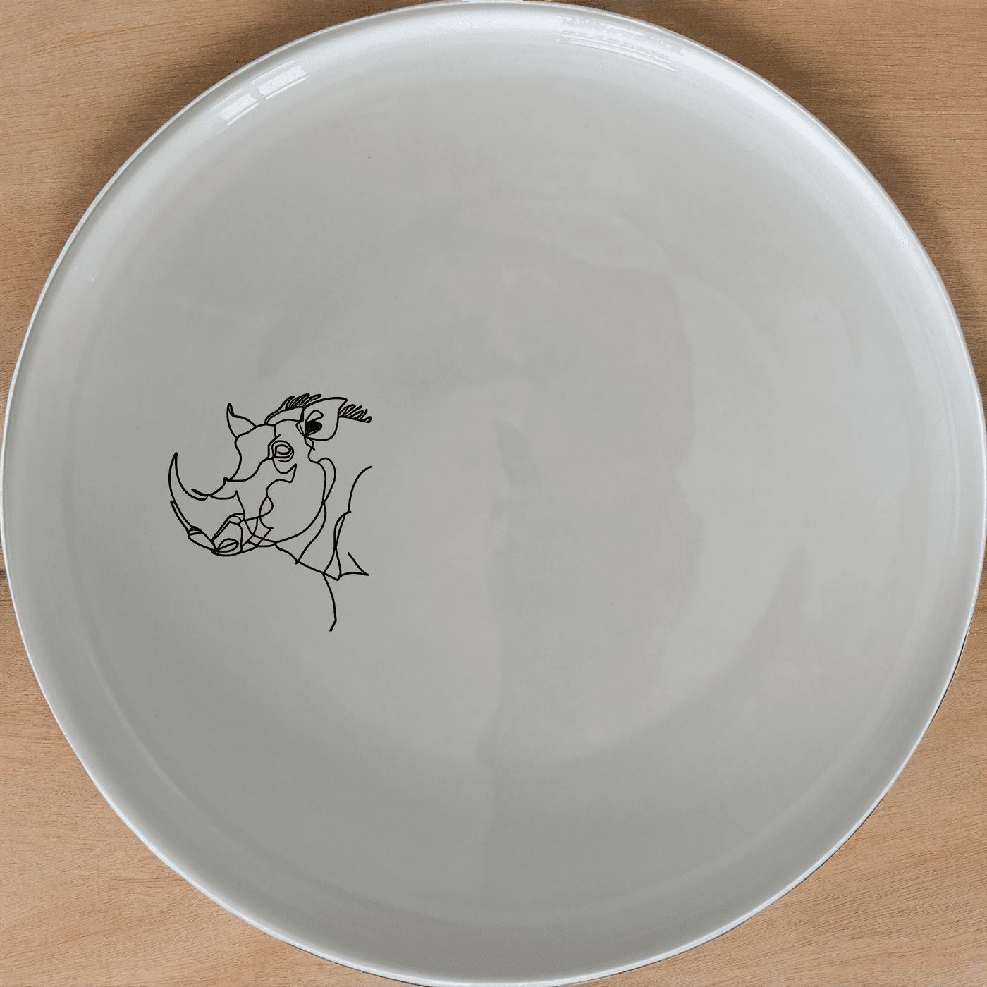 The Warthog Portrait Dinner Plate Set of 4 features a striking design that adds a touch of modern art to your dining table.