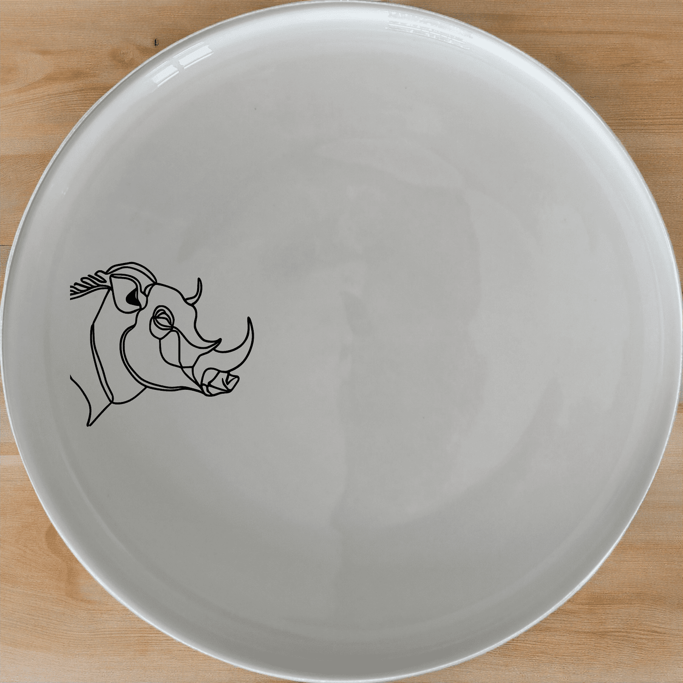 The Warthog Portrait Side Plate Set of 4 features a striking silhouette design, perfect for modern dining and adding a touch of nature to your table setting.