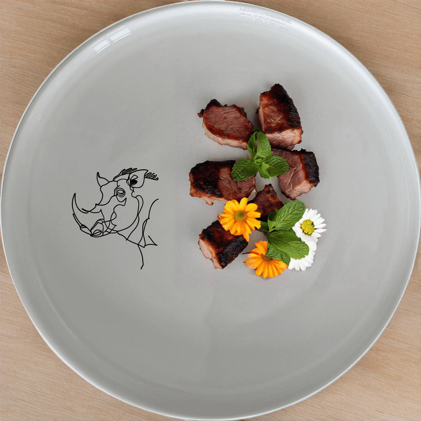 The Warthog Portrait Side Plate Set of 4 features a unique laser-etched design on a sleek white ceramic plate, perfect for adding a touch of art to your dining experience.