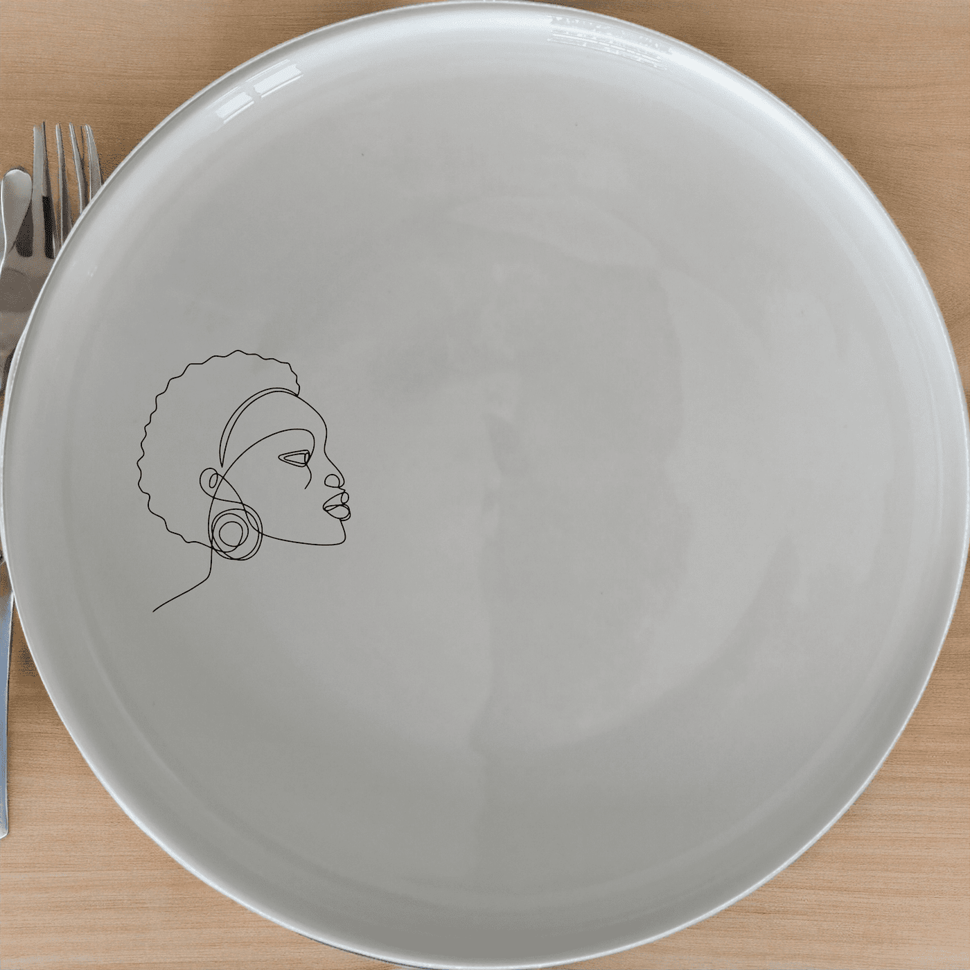 Young African Woman Dinner Plate Set of 4 - Range 1 adds a modern touch to your dining table with its sleek design and cultural inspiration.