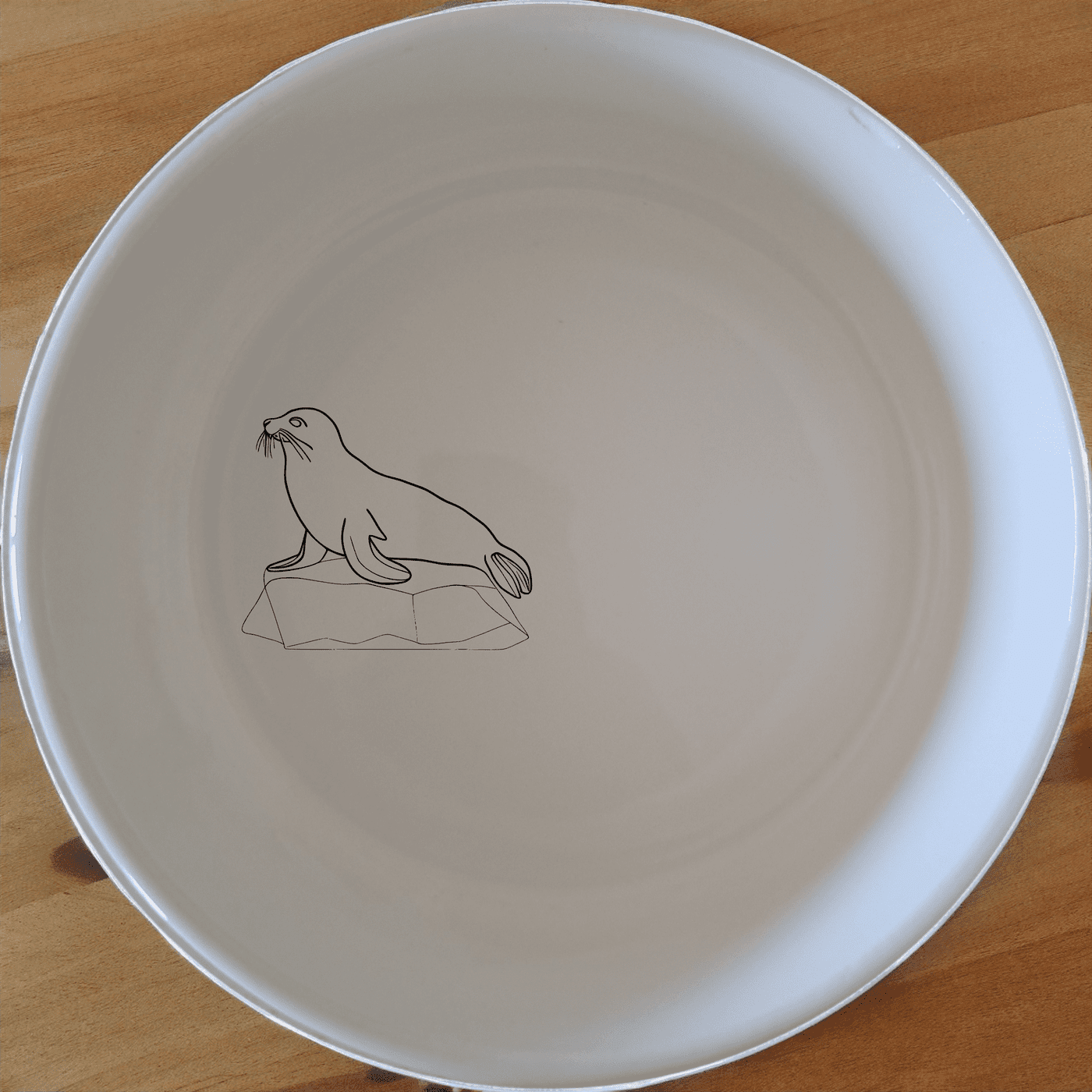 Abstract Harbor Seal Bowl Set of 4 - Range 4 is a beautiful and unique set of four white ceramic bowls featuring an abstract harbor seal design. Perfect for any kitchen or dining room.