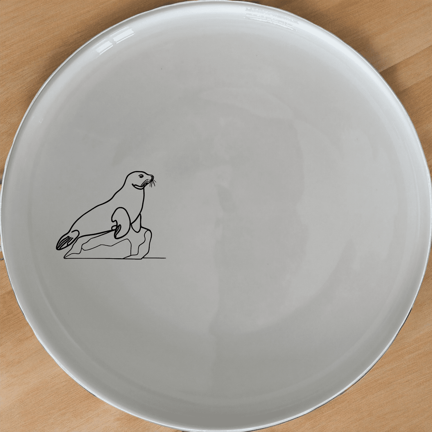 Harbor Seal Rock Dinner Plate Set of 4 - Range 1 is a beautiful and unique dinner plate set featuring a harbor seal on a rock design. Perfect for any home.