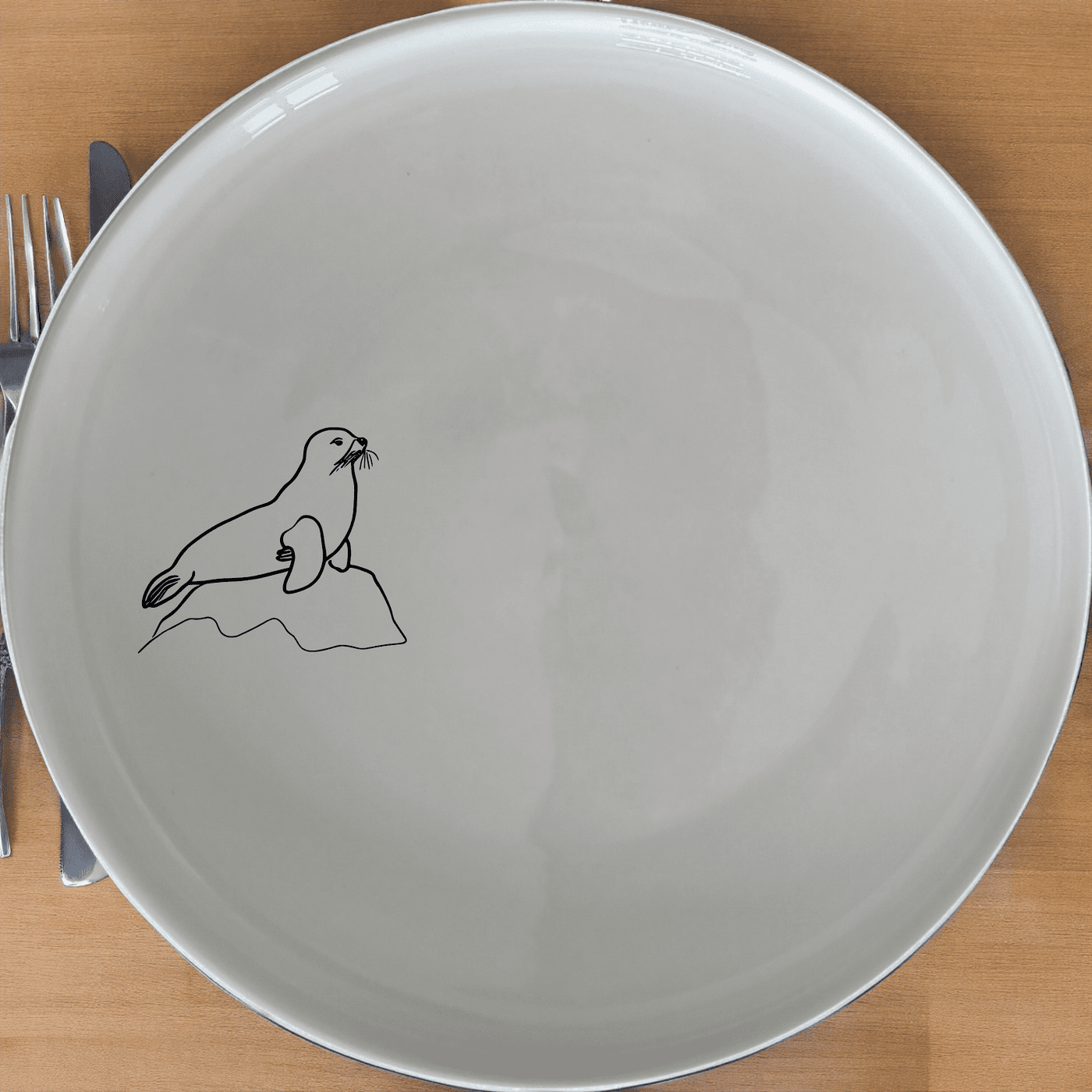 Harbor Seal Rock Dinner Plate Set of 4 - Range 2 is a stylish and elegant dinner plate set featuring a charming harbor seal design, perfect for adding a touch of nature to your dining experience.