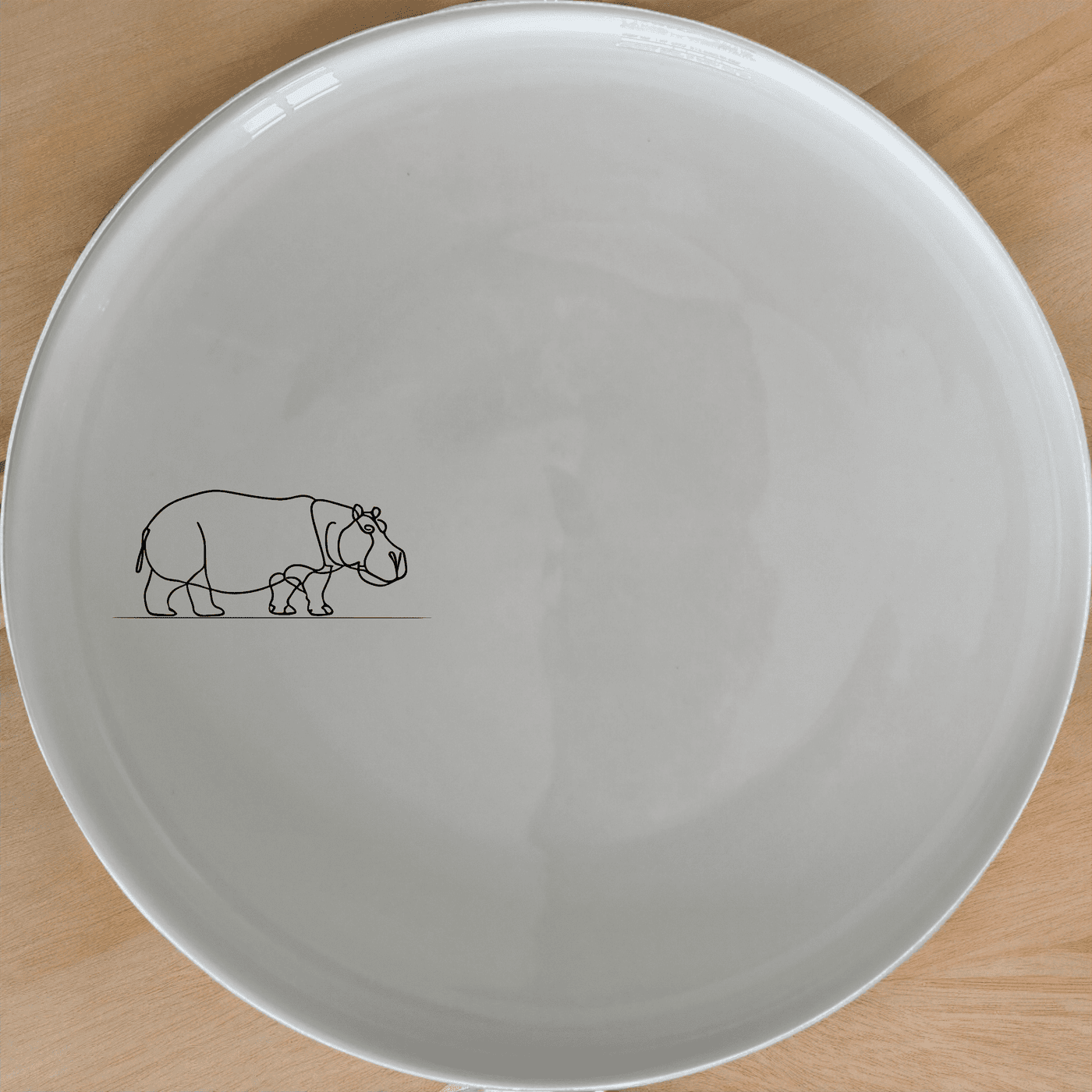 The Curvey Silhouette Hippo Side Plate Set of 4 - Range 4 features a sleek, modern design with a minimalist hippo silhouette etched onto each plate. Perfect for adding a touch of sophistication to any dining setting.