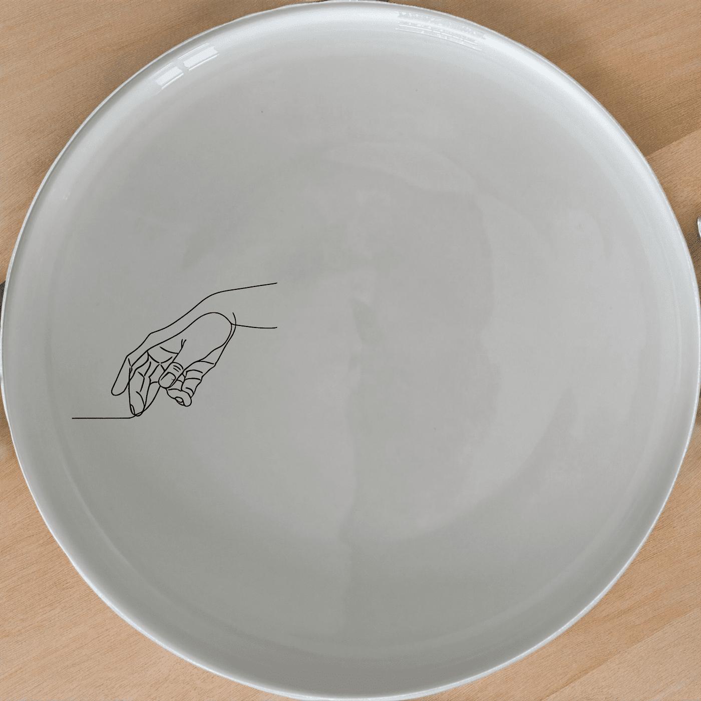 The Drawing Hand Dinner Plate Set of 4 - Range 1 features a minimalist design with a subtle hand illustration, perfect for modern dining.