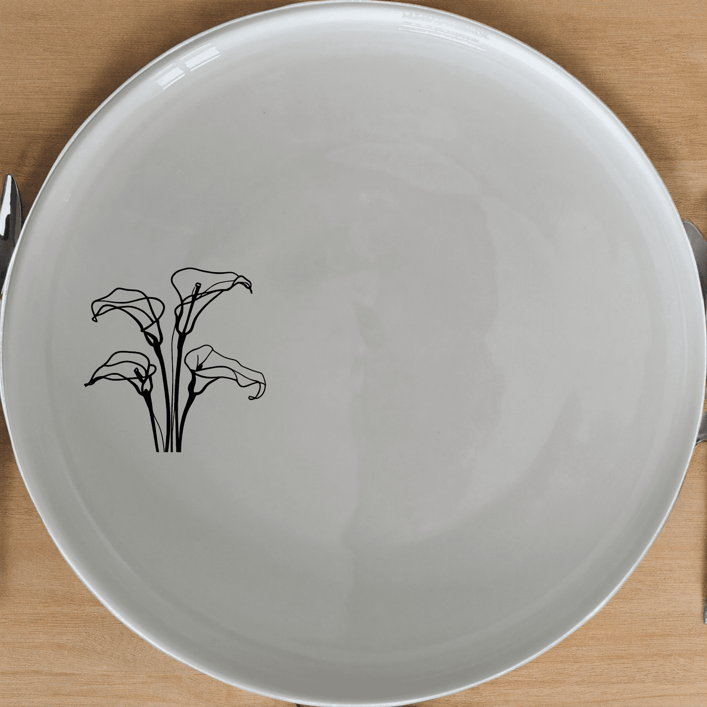 Arum Lilies Dinner Plate Set of 4 - Range 3 is a stunning set of four white ceramic dinner plates, each featuring a delicate laser-etched design of arum lilies. Perfect for adding a touch of sophistication to any dining table.