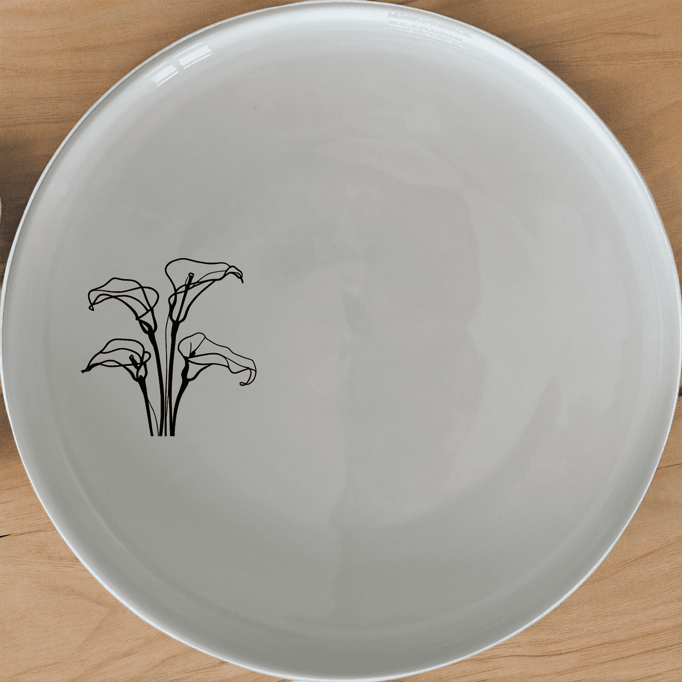 Arum Lilies Side Plate Set of 4 - Range 3 is a beautiful and versatile set of four white ceramic side plates, each featuring a delicate laser-etched design of arum lilies. Perfect for everyday use or special occasions, these plates are dishwasher and microwave safe, making them both practical and stylish.