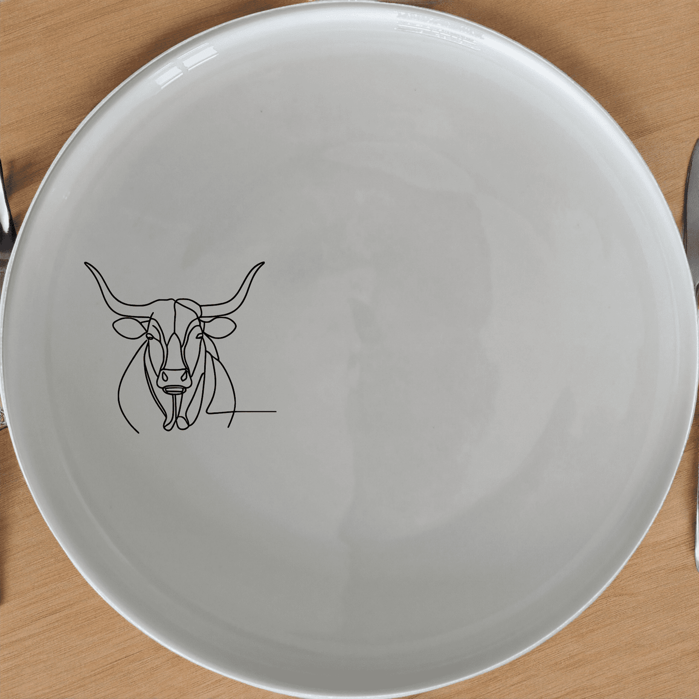 The Long Horn Steer Dinner Plate Set of 4 - Range 1 features a minimalist design perfect for modern dining. Crafted from durable ceramic, these plates are microwave and dishwasher safe, making them ideal for everyday use.