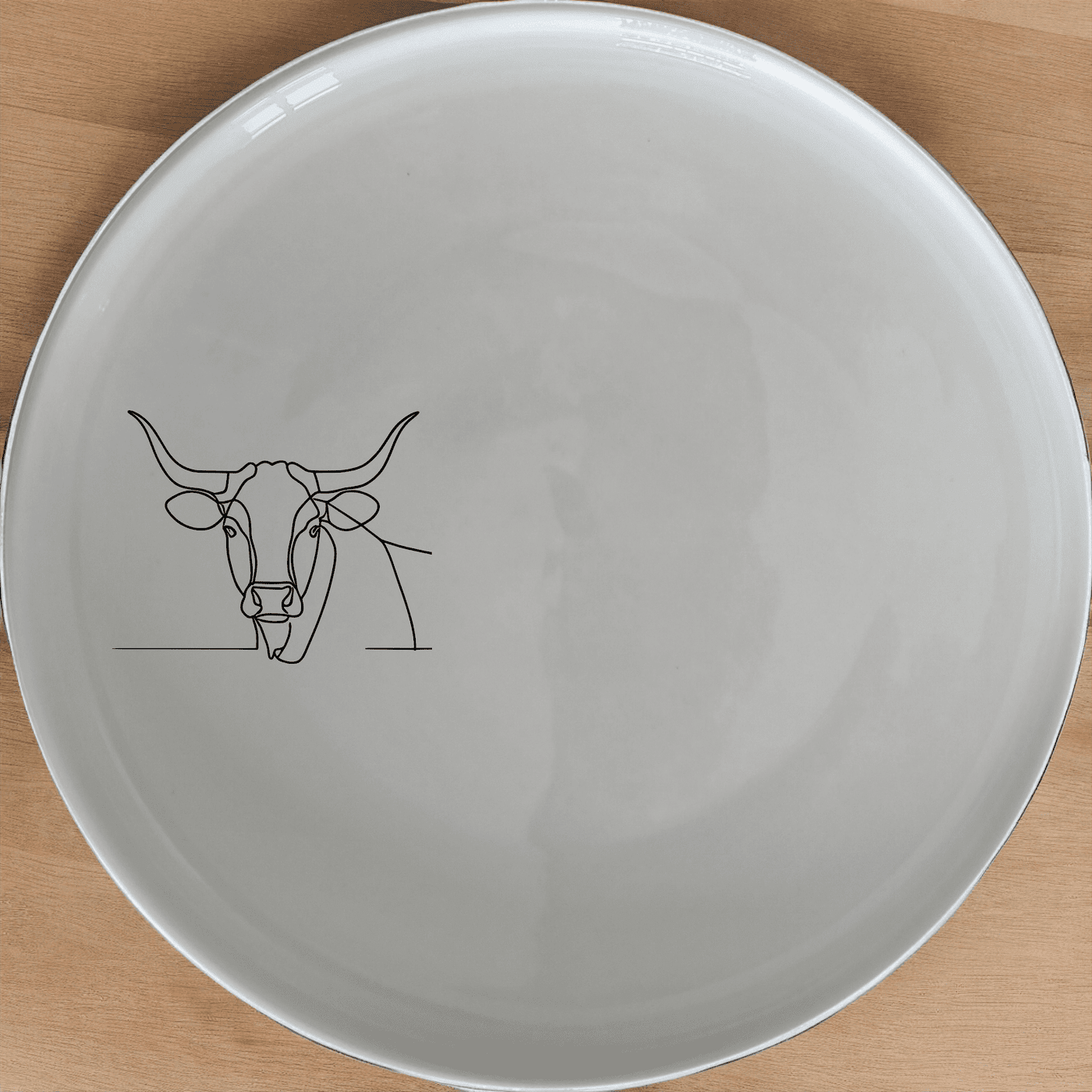 The Long Horn Steer Dinner Plate Set of 4 - Range 3 features a sleek, minimalist design perfect for modern dining. Crafted from durable ceramic, these plates are both dishwasher and microwave safe, making them ideal for everyday use.