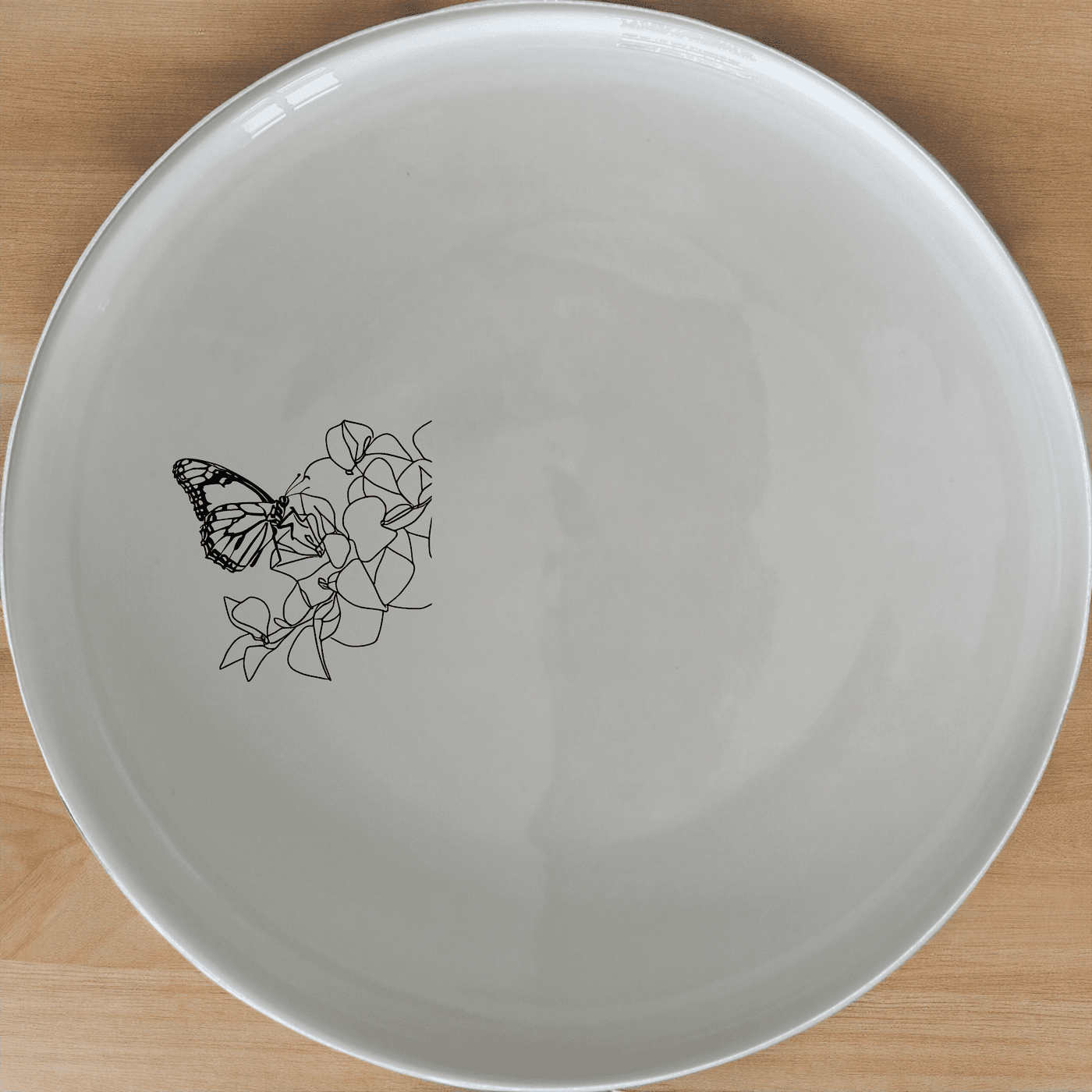 Monarch Butterfly Bougainvillea Dinner Plate Set of 4 - Range 4 is a stunning set of four dinner plates featuring a delicate laser-etched monarch butterfly design on a white ceramic base.