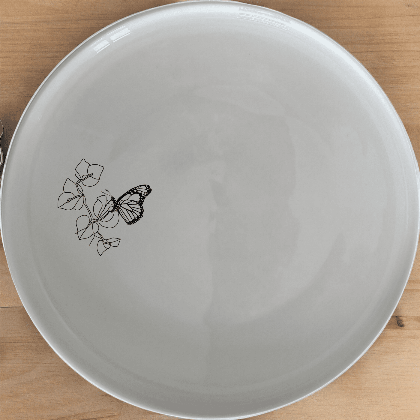 Monarch Butterfly Bougainvillea Side Plate Set of 4 - Range 3 is a stunning set of four 21cm white ceramic plates with laser-etched butterfly designs, perfect for adding a touch of elegance to any dining table.