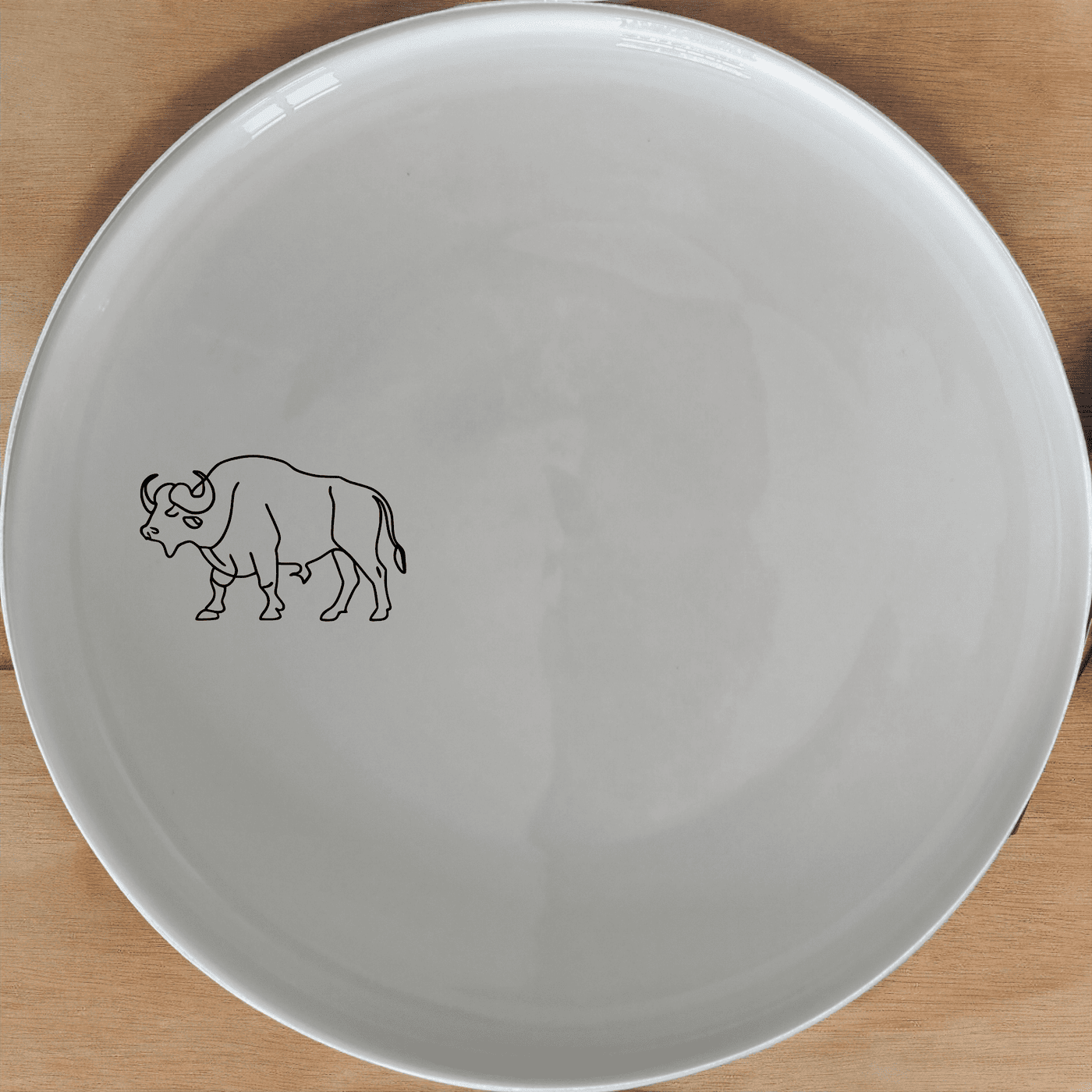 The African Buffalo Dinner Plate Set of 4 features a sleek silhouette design, perfect for modern dining settings.