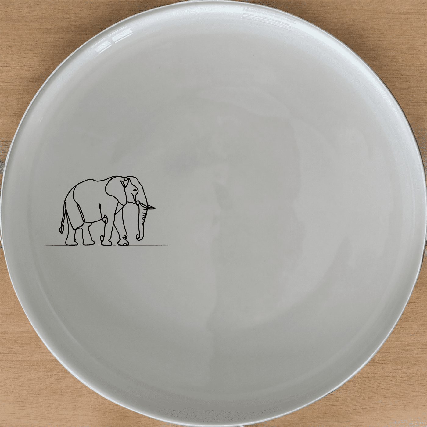 The Silhouette Big Five Elephant Dinner Plate Set of 4 features a minimalist design perfect for modern dining. Crafted from durable ceramic, these plates are both dishwasher and microwave safe, making them ideal for everyday use.