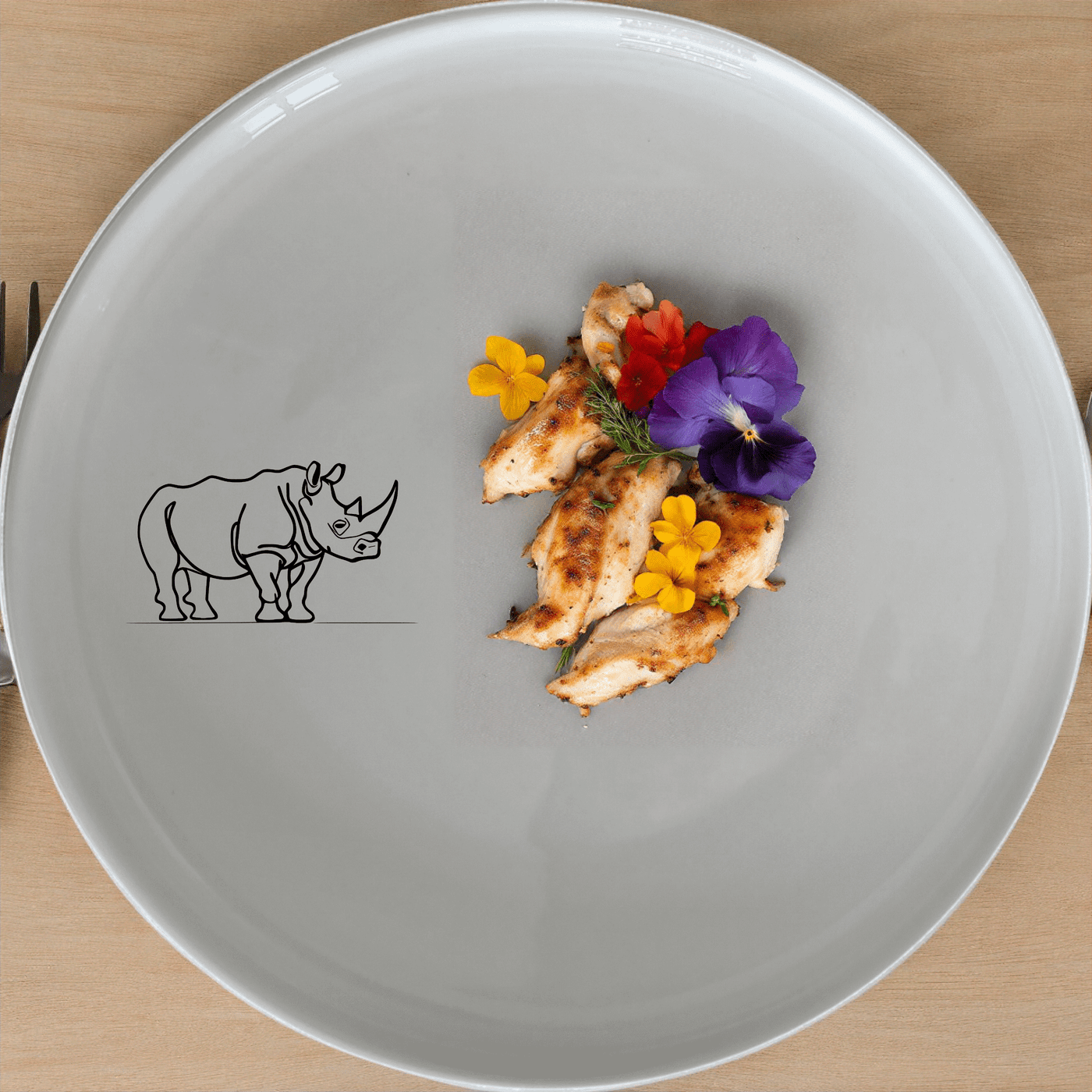 The Silhouette Rhino Dinner Plate Set of 4 features a striking black silhouette of an African rhino on a white ceramic plate, perfect for adding a touch of wildlife elegance to your dining table.