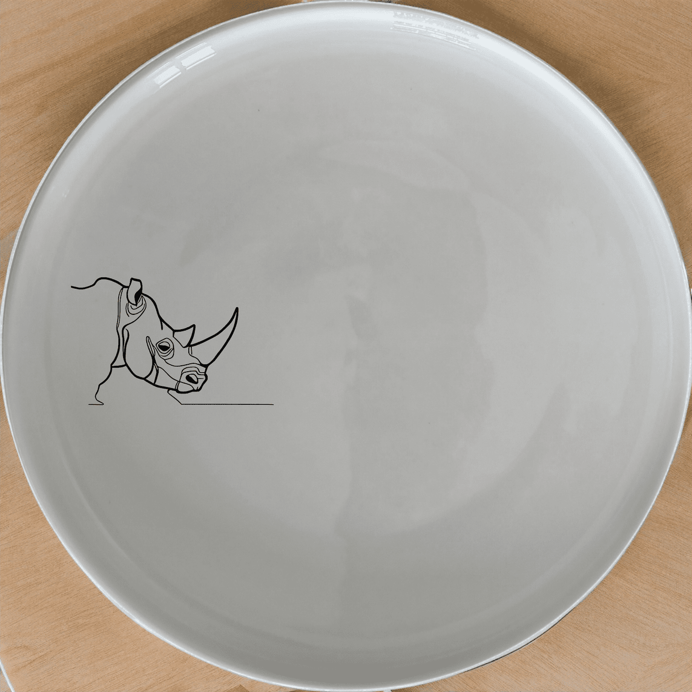 The Silhouette Big Five African Rhino Side Plate Set of 4 features a striking rhino silhouette design, perfect for adding a touch of wildlife elegance to your dining table.