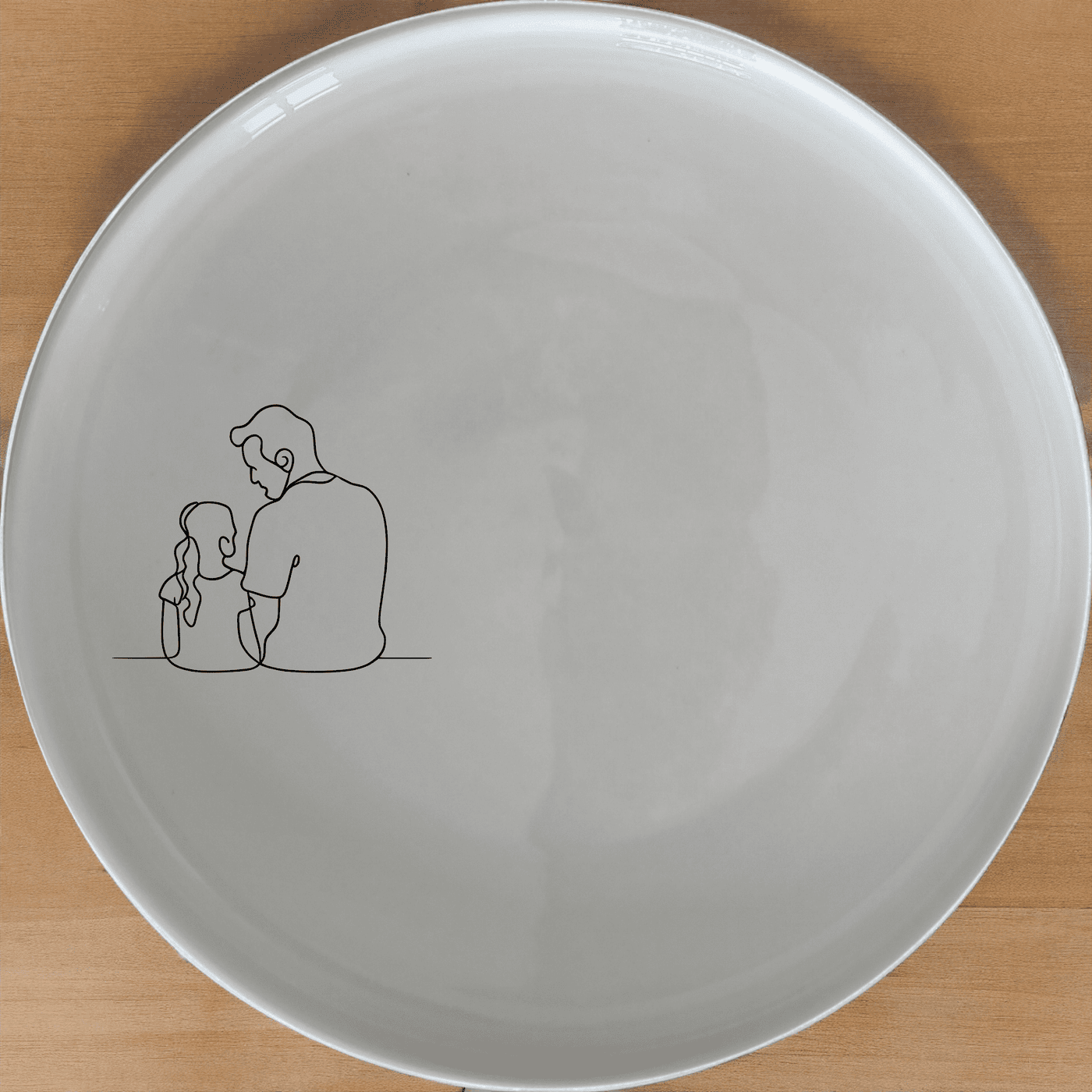 The Sillohette Father Daughter Dinner Plate Set of 4 - Range 1 is a beautiful and unique dinner plate set that features a laser-etched design of a father and daughter sitting together. This set is perfect for adding a touch of elegance to your dining table and is sure to be a conversation starter.